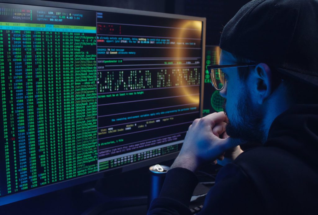 Free A Man Looking at a Computer Screen with Data Stock Photo